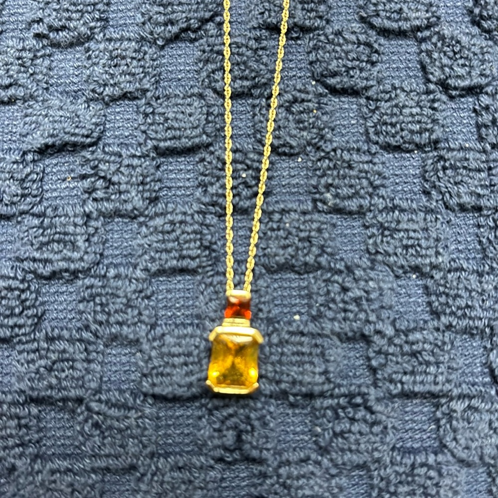 Gold necklace with garnet and citrine stones.